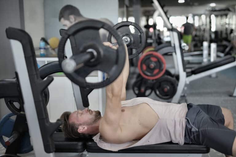 man using plate loaded strength machine