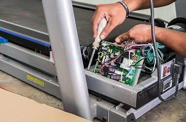 A treadmill being repaired