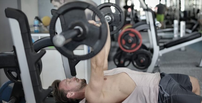 man using plate loaded strength machine